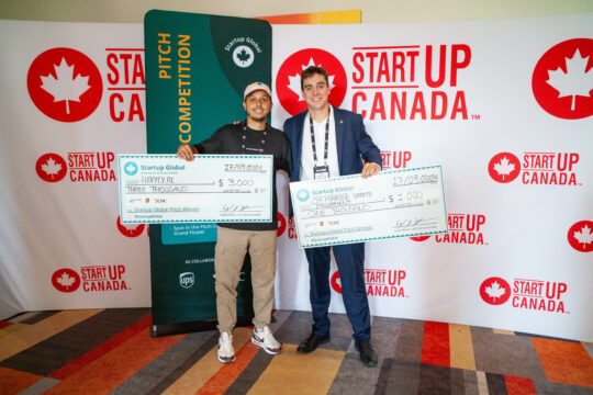 Thierry Lindor and Ben Collings Mackay, winners of the Moncton pitch competition with their cheques